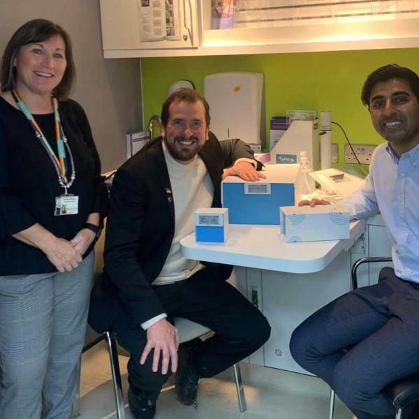 three adults in a hospital consulting room